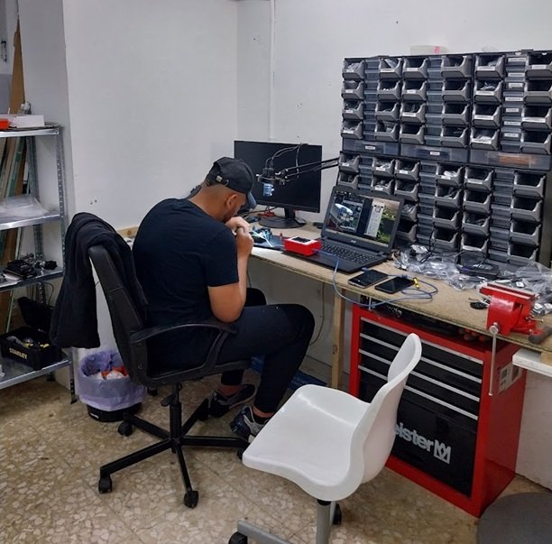 Técnico cualificado de Cerrajería Reyes operando equipos electrónicos avanzados en nuestro taller de Sabadell.